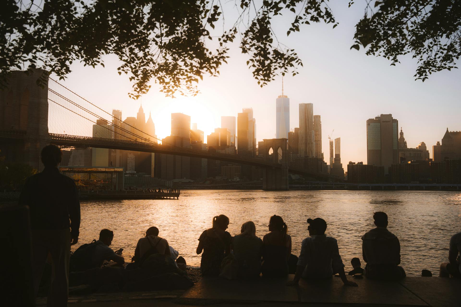 People watching the sunset from the Brooklyn Bridge walkway